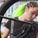 Female Technician Repairing Rotating Bike Wheel - VideoHive Item for Sale