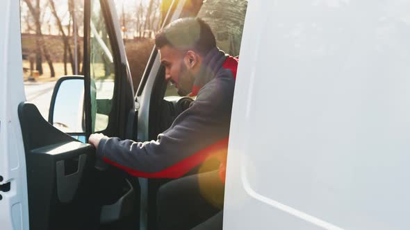 Young Indian Driver Getting Out of the Van Closing the Door and Smiling