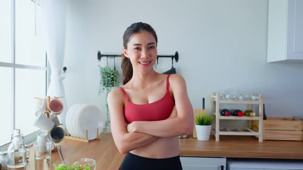 Portrait of Asian active woman in sportswear look at camera enjoy eat clean water after exercise.