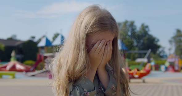 Caucasian Preschool Girl Crying Alone on Playground at Park