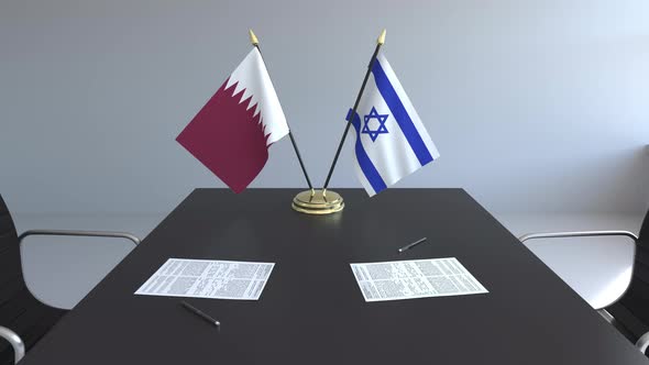 Flags of Qatar and Israel on the Table