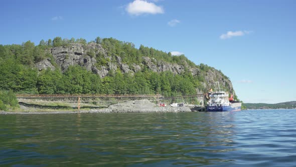 Oil mining company in Norwegian coastal fjords, boat view