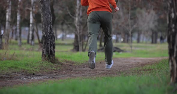 Male Legs Jogging Running in a Park Slow Motion