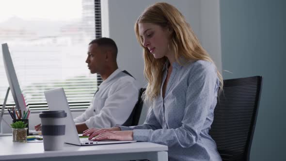 Man and woman working on computers