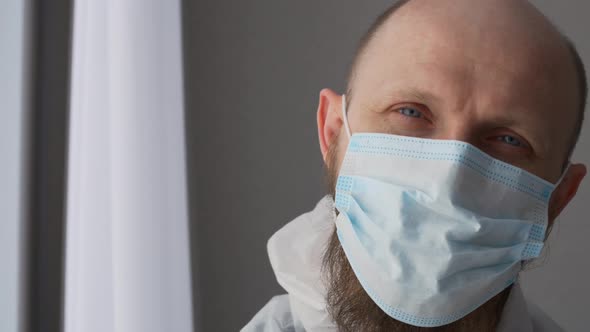 Closeup of a Man in a Mask As a Laboratory Assistant in a Medical Facility