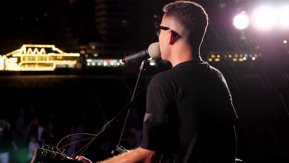 A Rock Music Player is Performing Onstage at Rock Festival Closeup