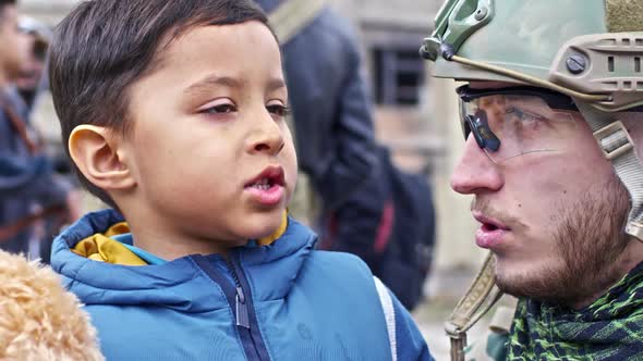 Soldier Talking to Refugee Boy