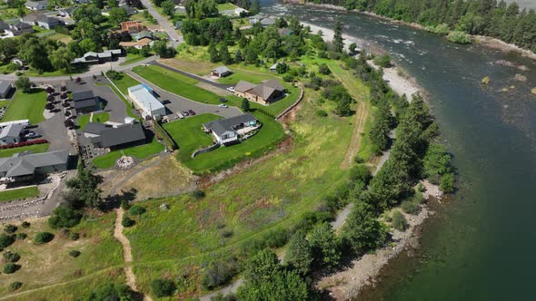 Wide orbiting aerial shot of the million dollar properties bordering the Spokane River.