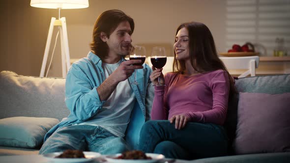 Young Couple in Love Drinking Wine Together Man Toasting with Girlfriend Spending Romantic Evening