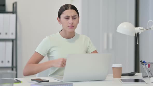 Young Latin Woman with Laptop Having Back Pain