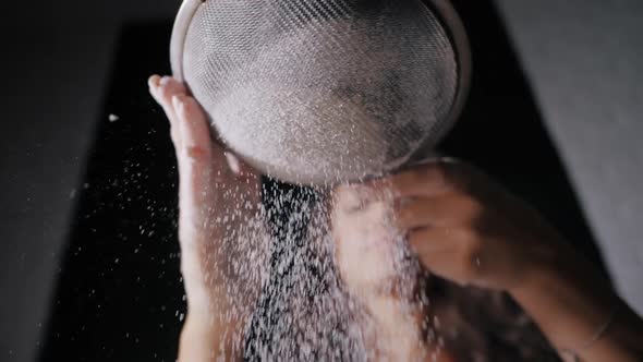 Closeup Woman Sifts Flour Through a Sieve While Baking