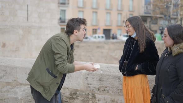 Magician Man Showing Street Magic Trick with Cards