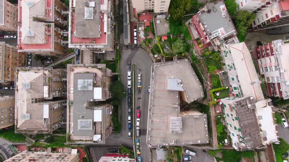 Cityscape of Genoa with streets and vehicles in top down aerial view