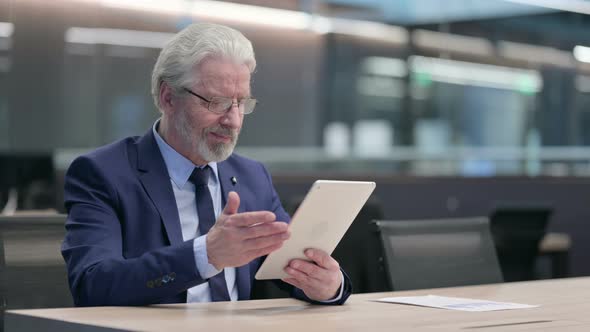 {Old Businessman Using Tablet at Work