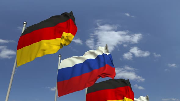 Flags of Russia and Germany Against Blue Sky