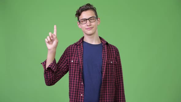 Young Handsome Teenage Nerd Boy Pointing Finger Up