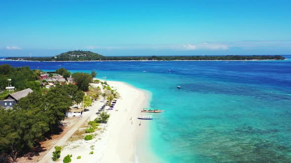 Aerial top view seascape of tropical tourist beach break by blue lagoon and white sand background of