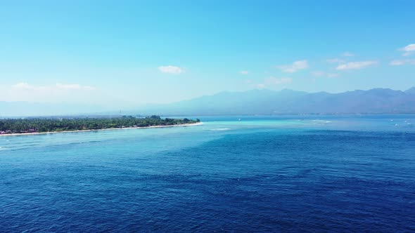 A Beautiful Scenery in Indonesia With Glorious Trees and Blue Calm Ocean - Aerial Shot