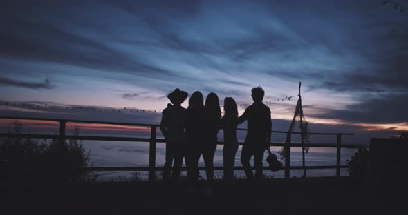 Silhouette of group of friends at sunset