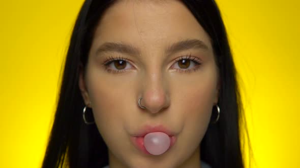 Attractive Girl Chawing and Blowing Bubble Gum Ball Pop It in Slow Motion
