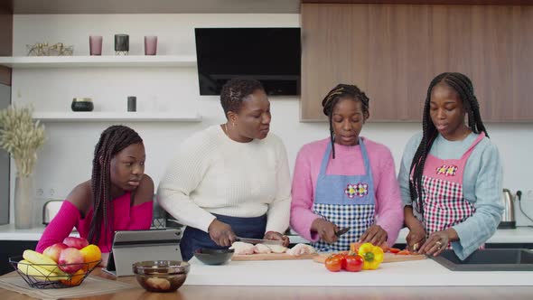 United Black Family Preparing Lunch Together in Kitchen