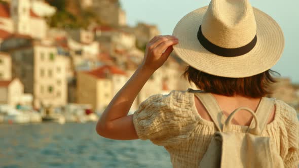 Happy woman looking at the sea on vacation, slow motion