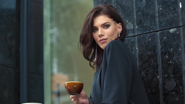 Woman in Business Suit Drinking Tea