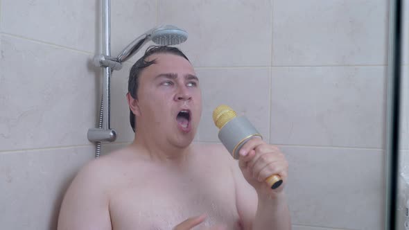 Cute Emotional Plump Man Sings Karaoke with Gold Microphone Taking Shower in Bathroom