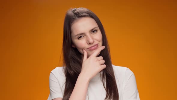 Blonde Woman Thinking Over Smart Idea Pondering Against Yellow Background