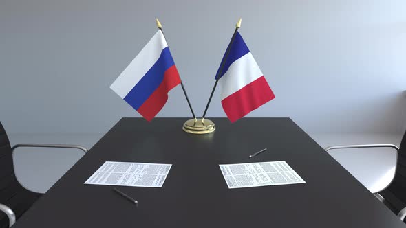 Flags of Russia and France and Papers on the Table