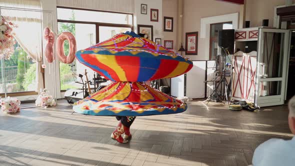 Unrecognizable person dancing national dance tanura indoors. Man show traditional performance