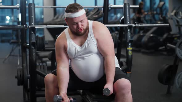 Fat Burning Overweight Funny Man Performs Exercises with Dumbbells Pumps the Biceps Motivation