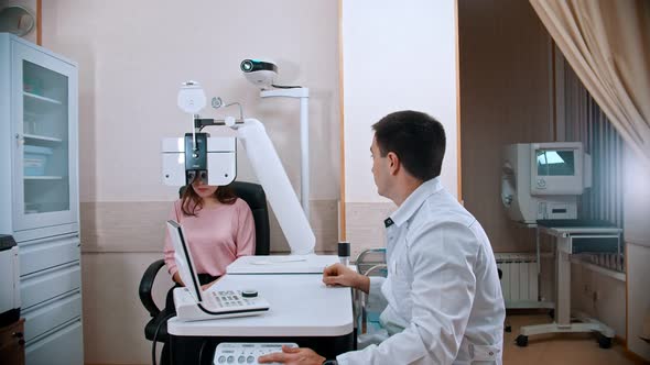 Ophthalmologist Begins To Examine  Womans Eyes