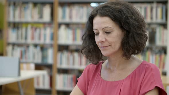 Closeup Shot of Beautiful Mature Woman Sitting at Library