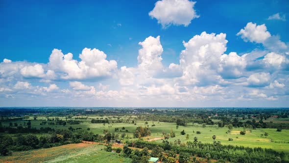 time lapse of beautiful Green farming community and a factory on a beautiful cloudy day.