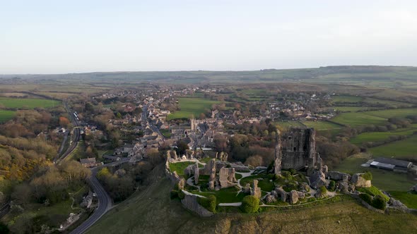 Panoramic view of Colfe Castle ruins during golden hour, County Dorset in England. Aerial sideways