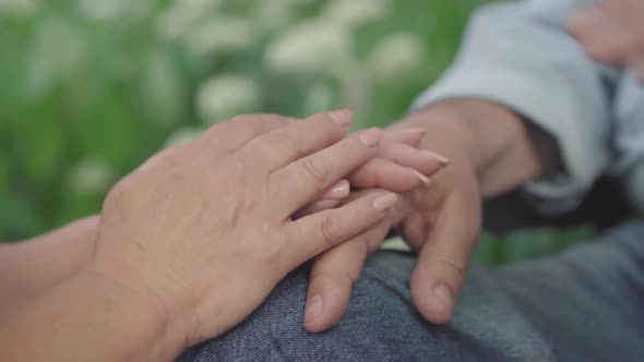 Close-up of Old Male and Female Hands Holding Each Other. Unrecognizable Loving Man and Woman