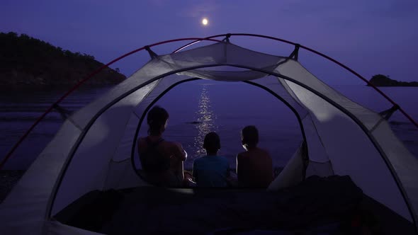 Mom with Children in the Tent at Night