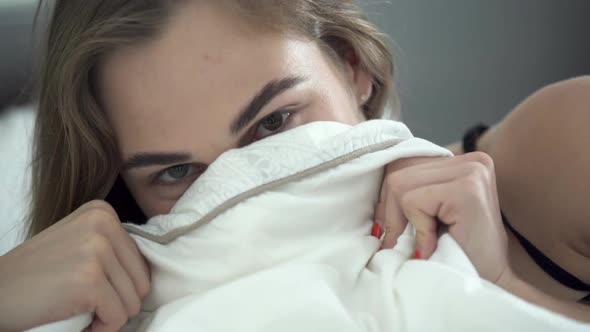 Portrait Pretty Young Happy Caucasian Woman with Different Colored Eyes Lying in Bed in the Morning