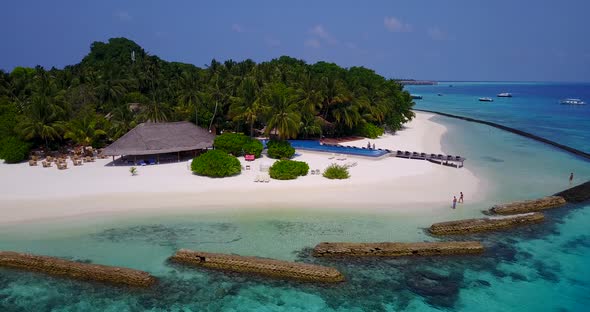 Wide angle aerial island view of a white paradise beach and blue sea background 