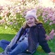 Happy Girl Laughs on a Lawn in a Flower Garden - VideoHive Item for Sale