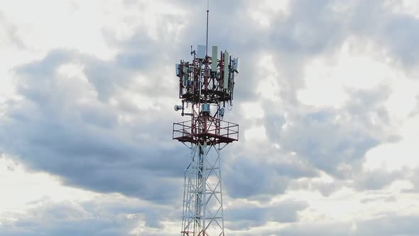 Aerial View Shot By Drone Telecommunication Base Station With  Clouds And Blue Sky.