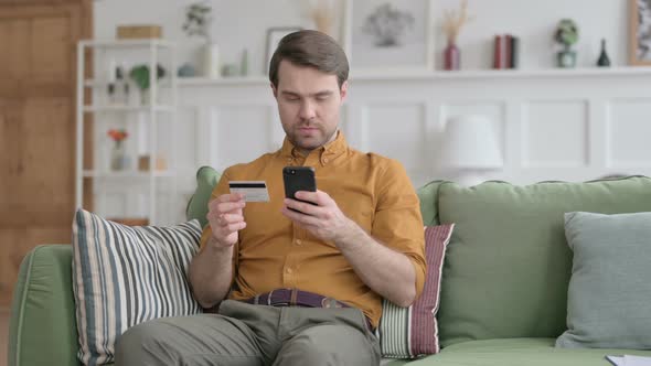 Young Man making Online Payment on Smartphone