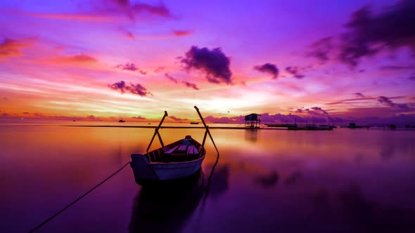 Colorful sunset above the sea surface with boats