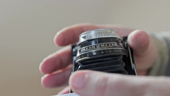 Close-up vintage photo camera details, setting up the film camera.