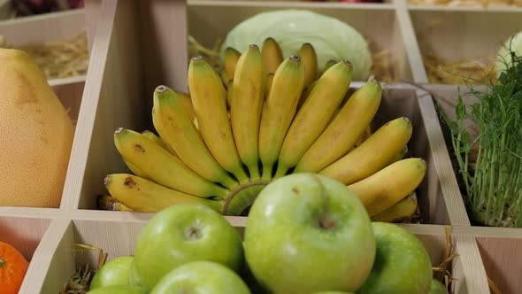 Closeup of Various Fruits on the Shelves in the Store Green Apples and Bananas