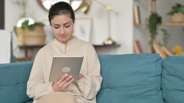Indian Woman Using Tablet on Sofa