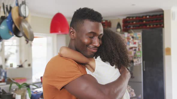 African american father and daughter hugging