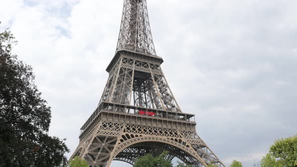 The Eiffel tower famous symbol of france and Paris slow tilt 4K 2160p 30fps UltraHD footage - French