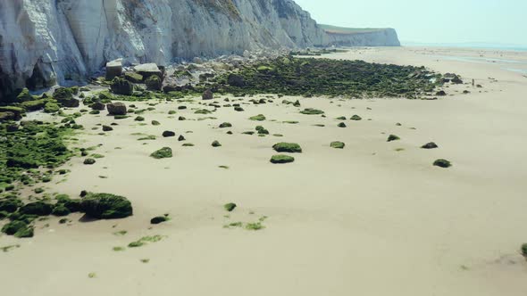 Limestone, moss rocks and 2 people on the beach, Cap Blanc Nez, France